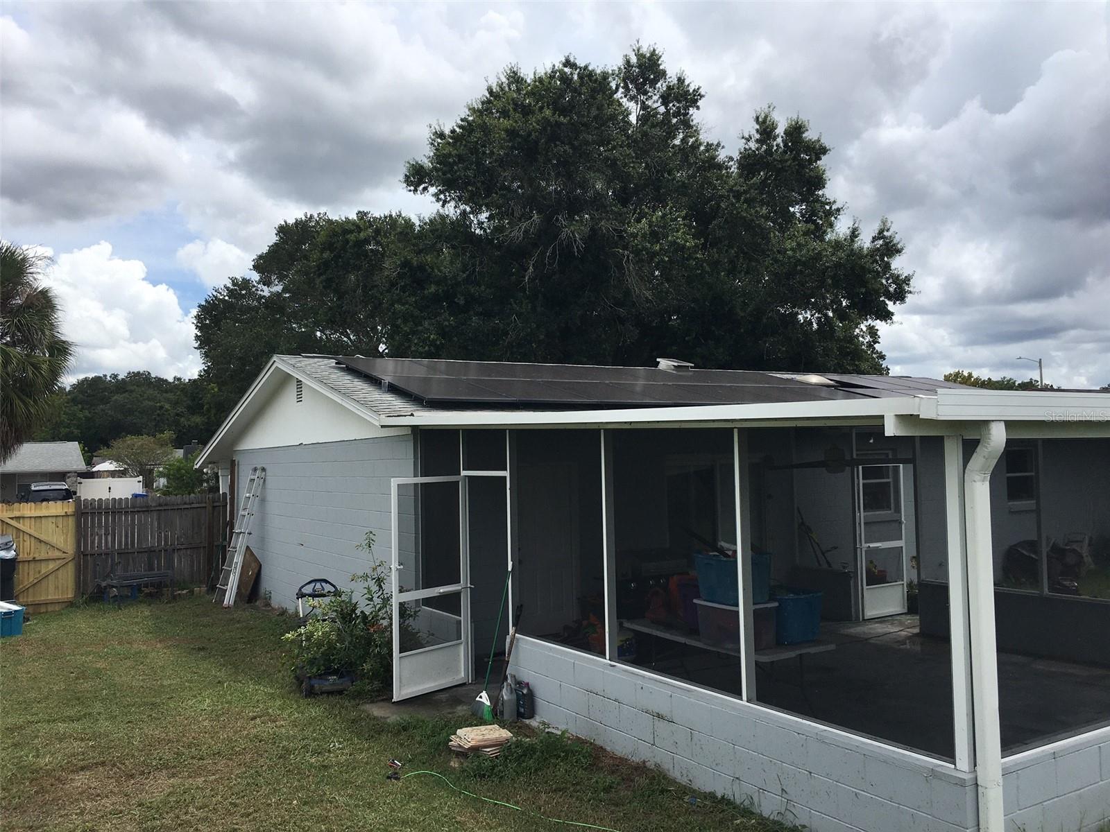 North side of house showing access to Lanai and gate on fence to the front yard