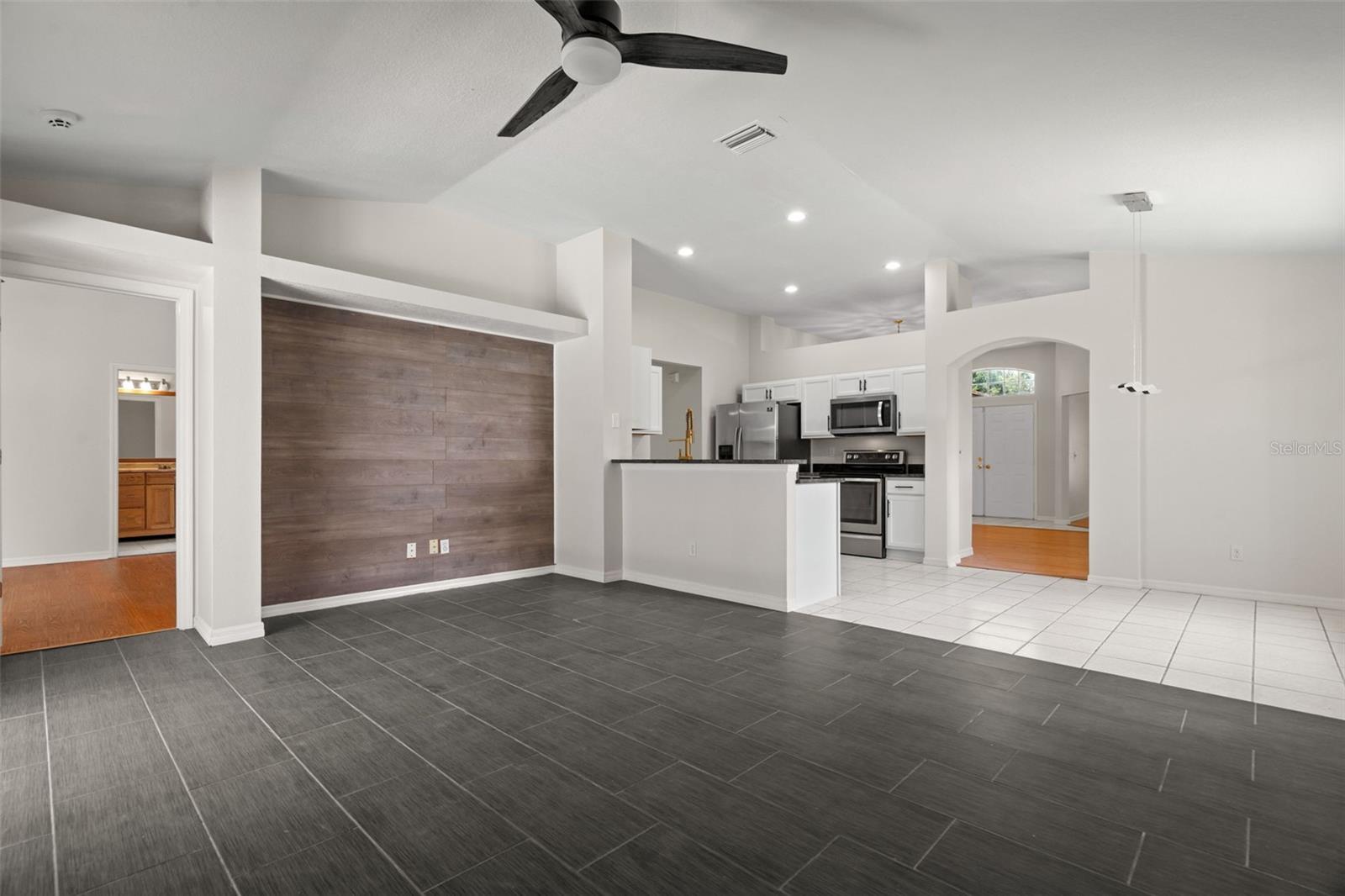 Large Family Room with Brand New Ceramic Tile Floors, Open Floor Plan and Breakfast Nook and Remodeled Kitchen.  Split Floor Plan allows for Primary Suite to be separate from other Bedrooms.