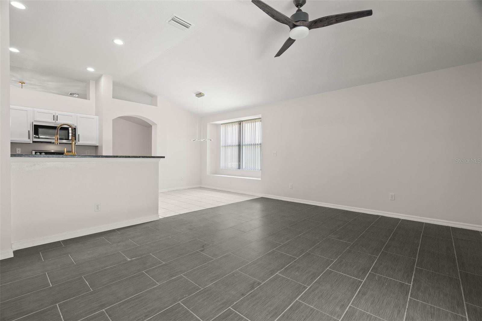 Large Family Room with Brand New Ceramic Tile Floors, Open Floor Plan and Breakfast Nook and Remodeled Kitchen.