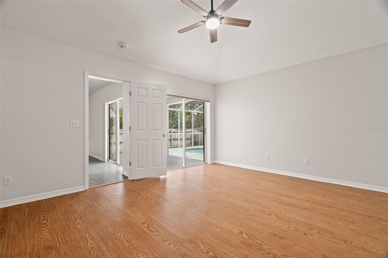 Primary Bedroom with Walk-In Closet, Sliding Glass Doors to Pool