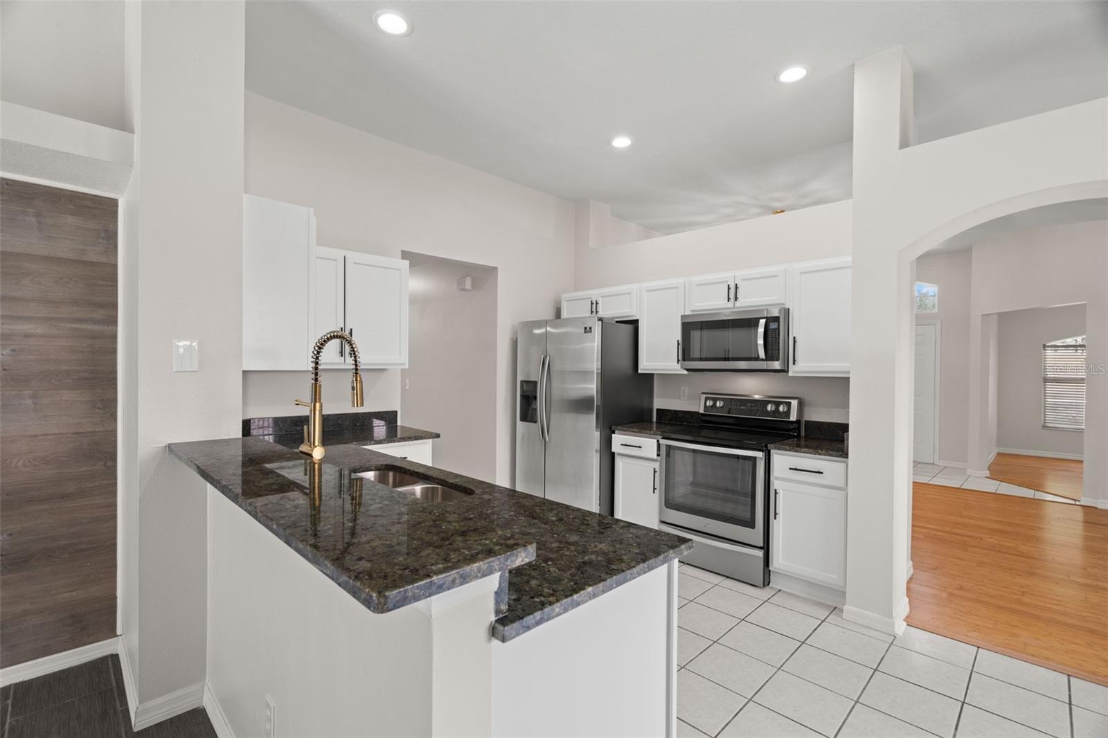 Complete Kitchen Remodel and Update  with Granite Countertops, Brand New Stainless Steel Appliances, High End Fixtures, New Garbage Disposal.