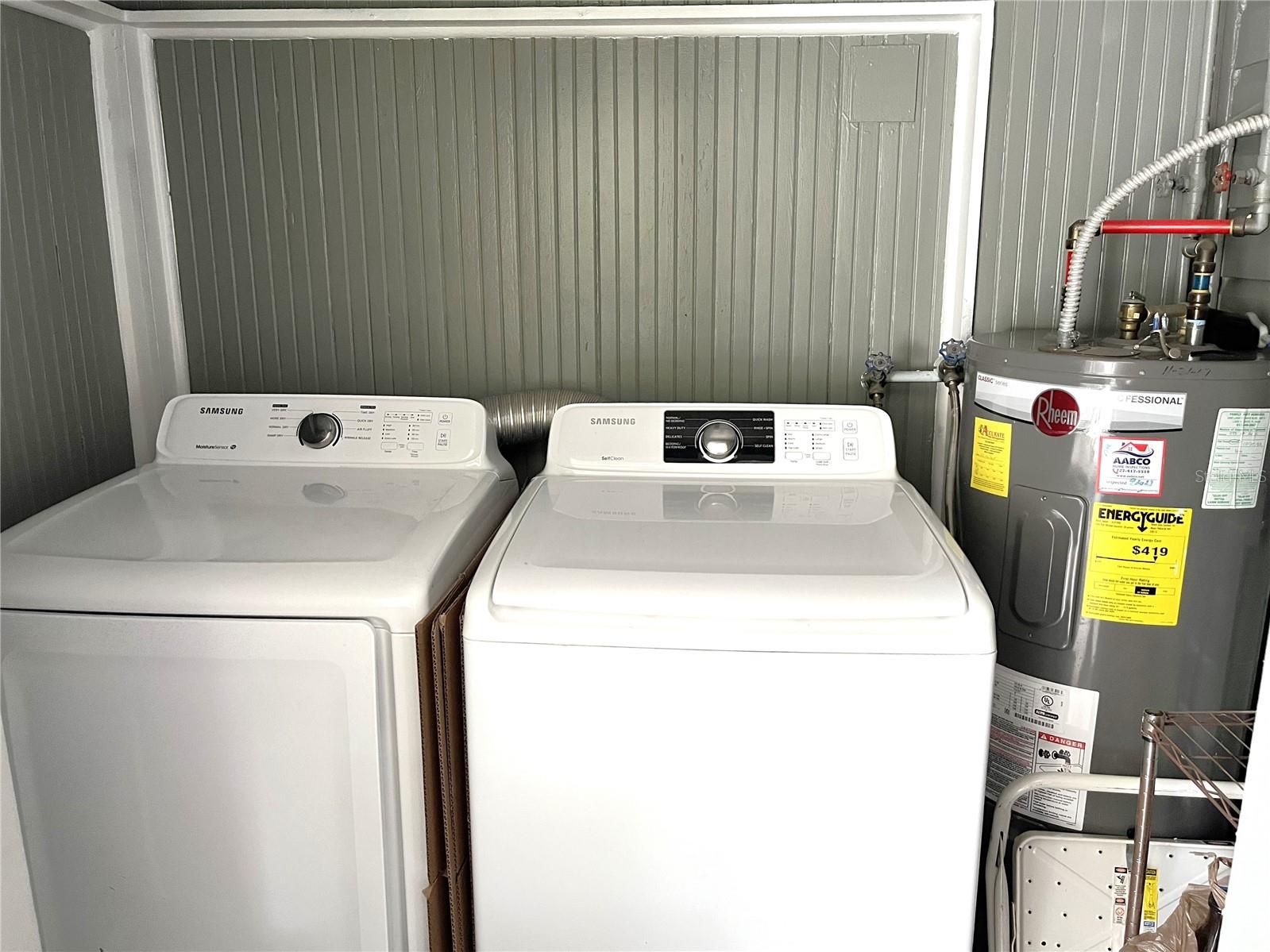 New washer, dryer and hot water heater on covered back porch of main house.