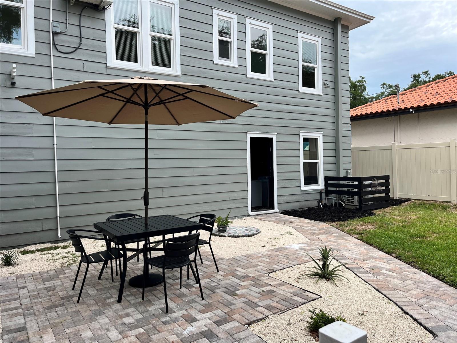 Courtyard with view of apartment laundry door. Contains new washer, dryer and hot water heater