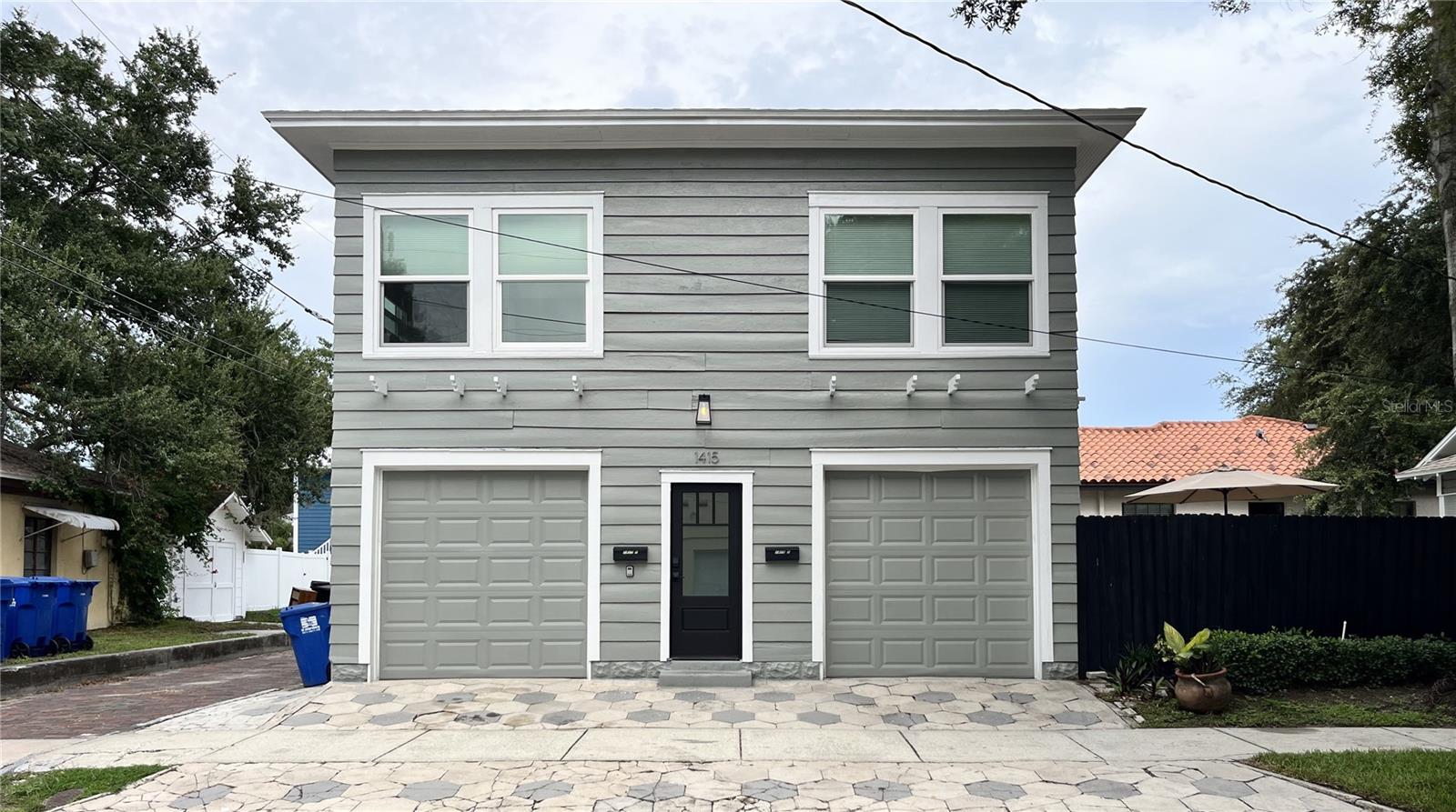 Each apartment has a separate garage. Enter stairs to take you to either apartment on the street side. Two car garage for main house on the alley (left side of unit.)