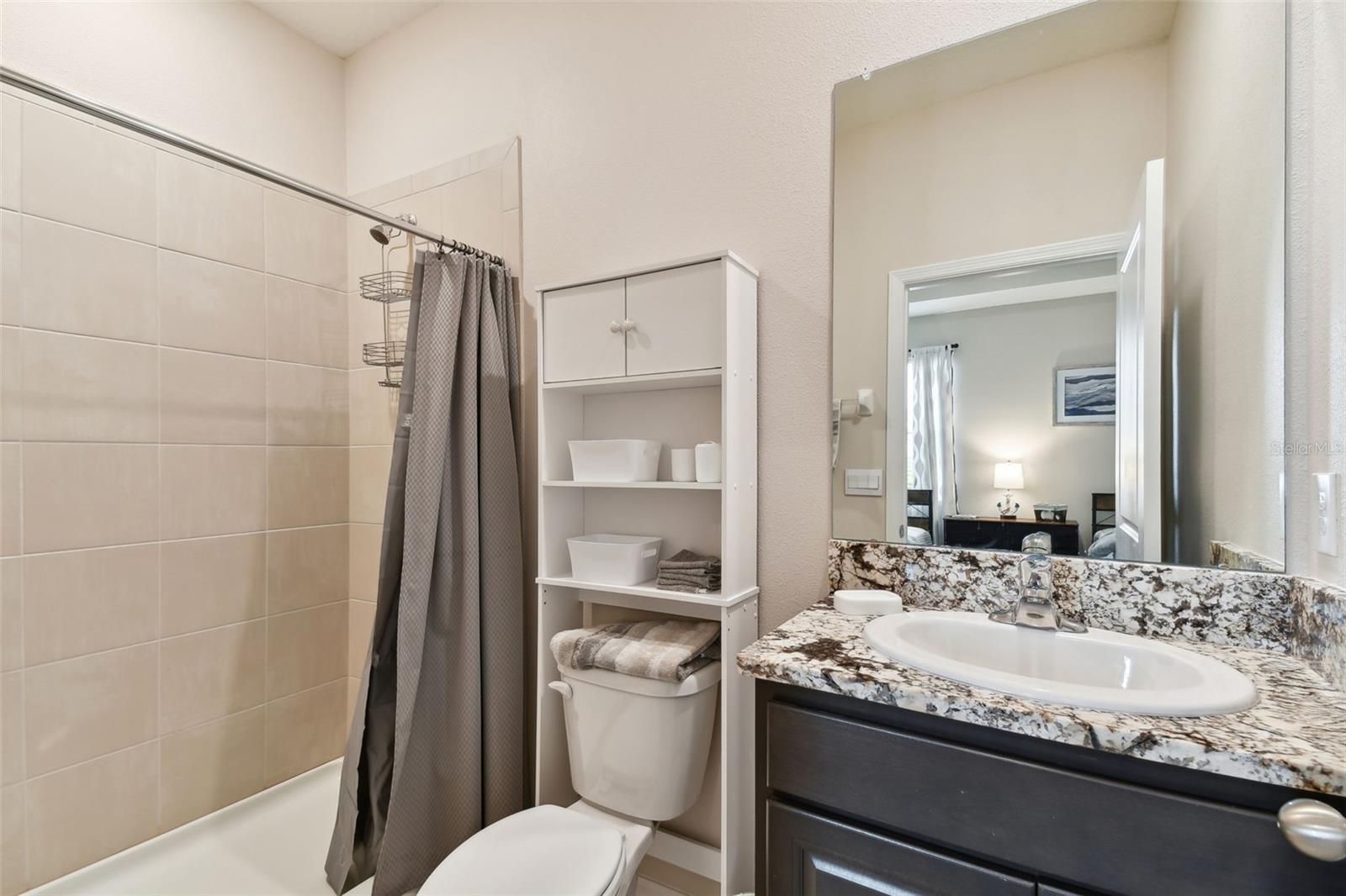 ensuite bath with granite and tub and shower