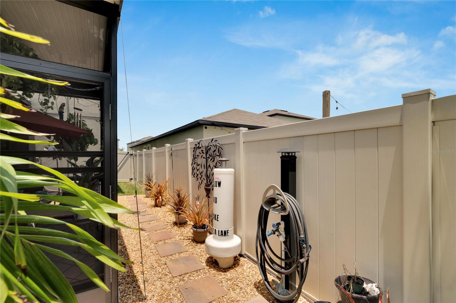 outdoor shower with rocks to exterior gate