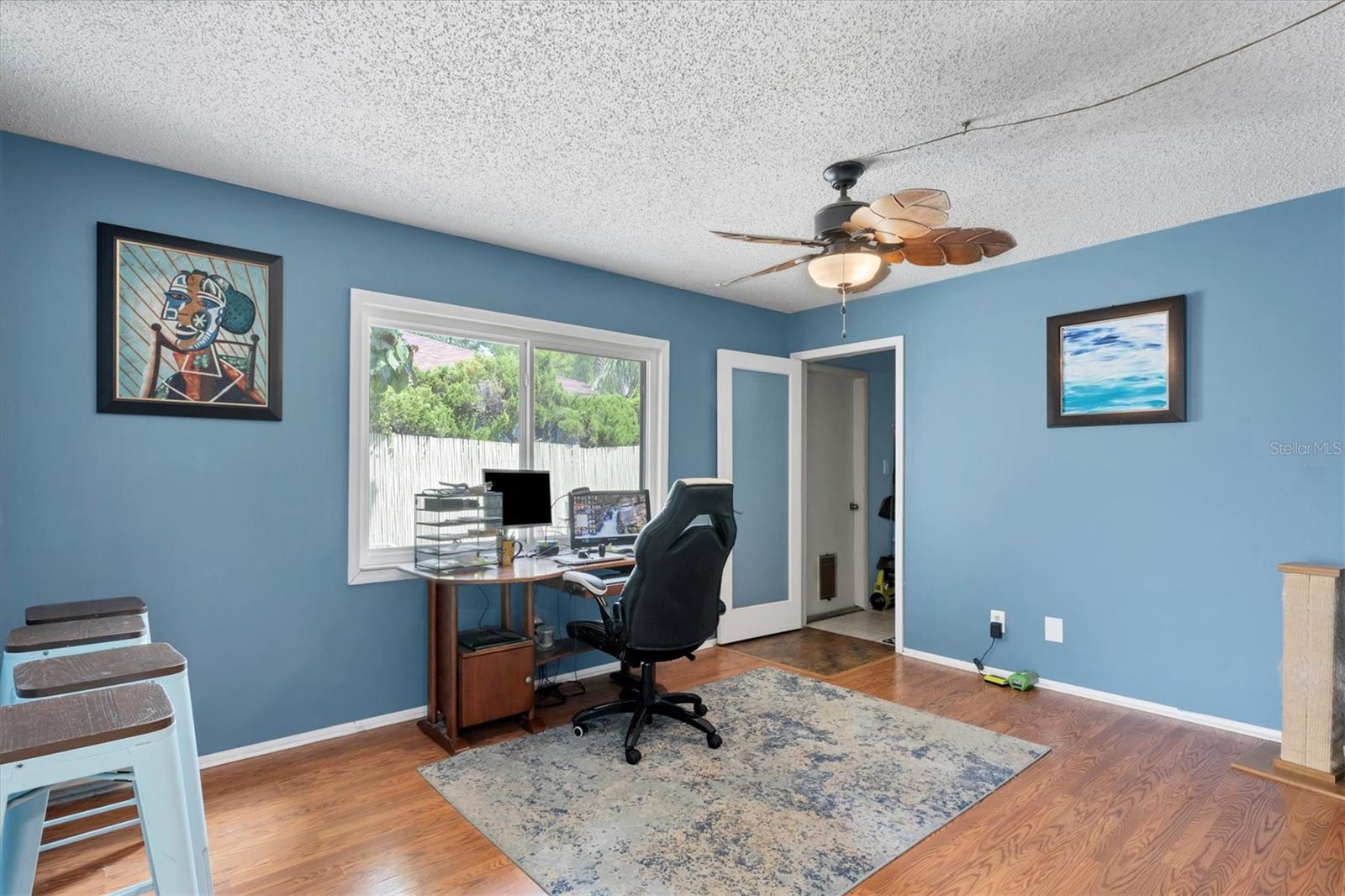 2nd living area leading to laundry room and door to patio.