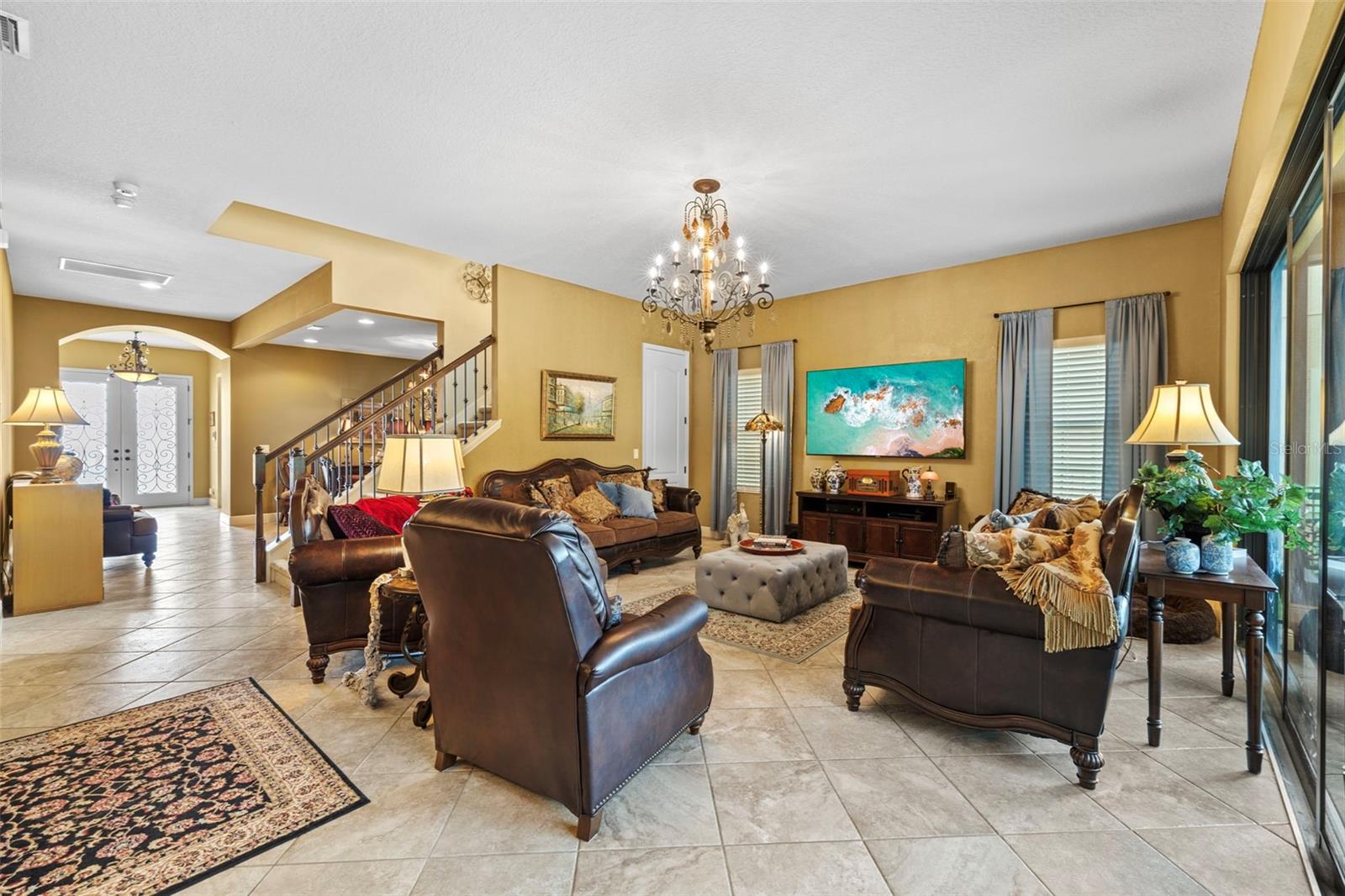 Spacious living room with custom chandeliers.