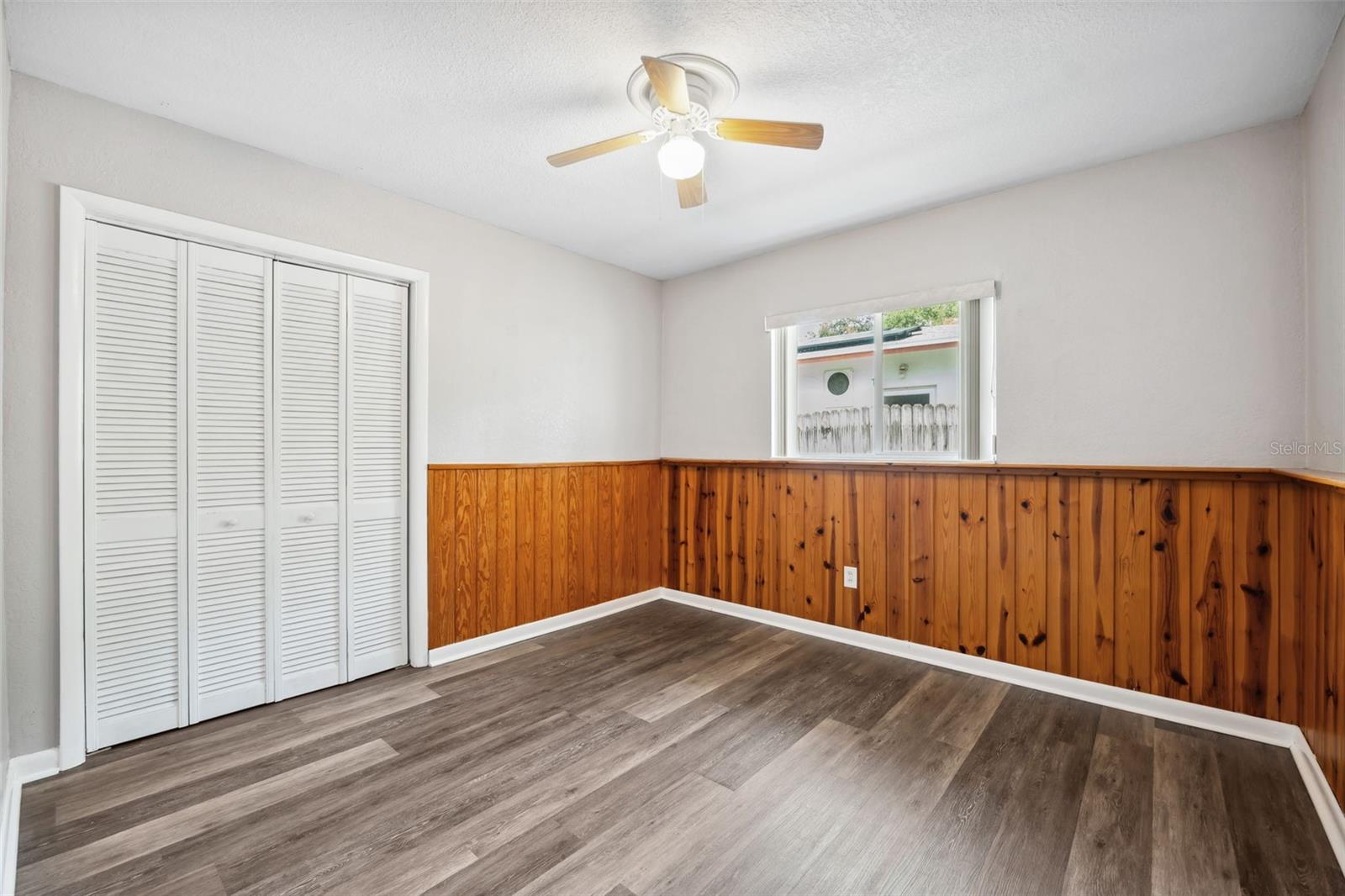 Pine wainscotting gives this third bedroom extra charachter