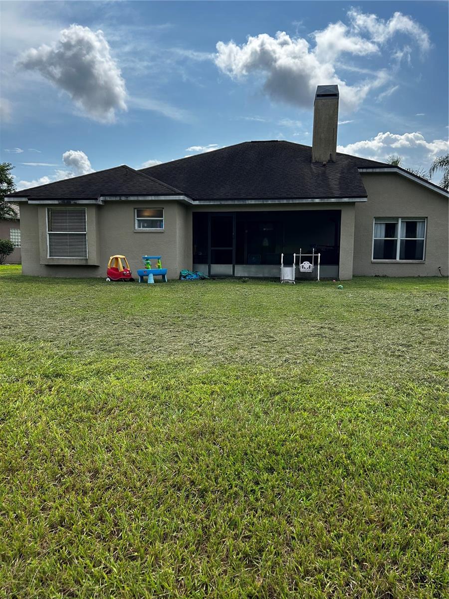 back of the house with a screened enclosure