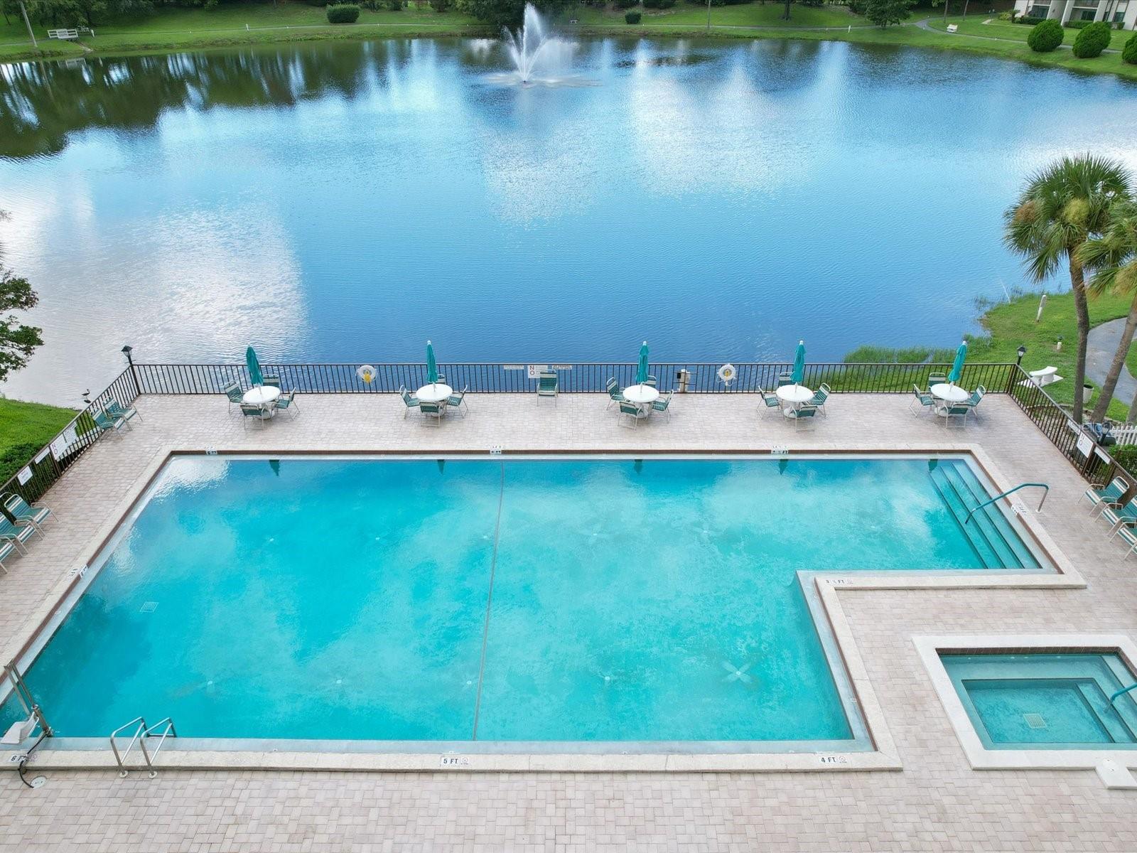 Beautiful heated community pool overlooking pond