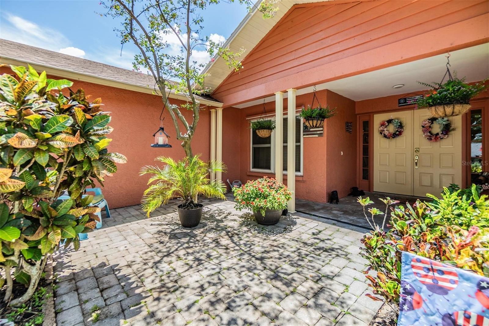 Great curb appeal with paver walkway to large covered double door front entrance