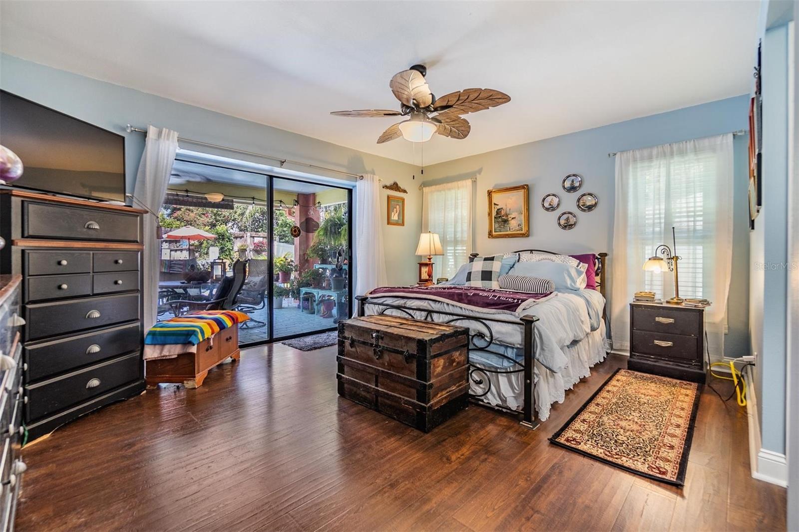 Primary bedroom with sliding glass doors out to pool, walk-in closet and ensuite bath