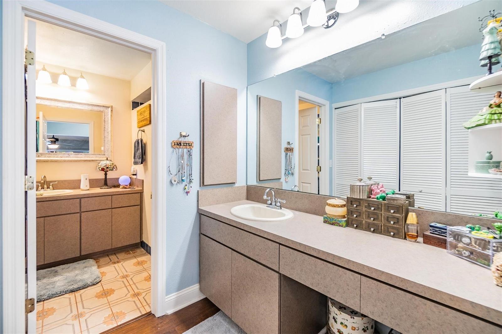 Dressing area across from walk-in closet in primary bedroom