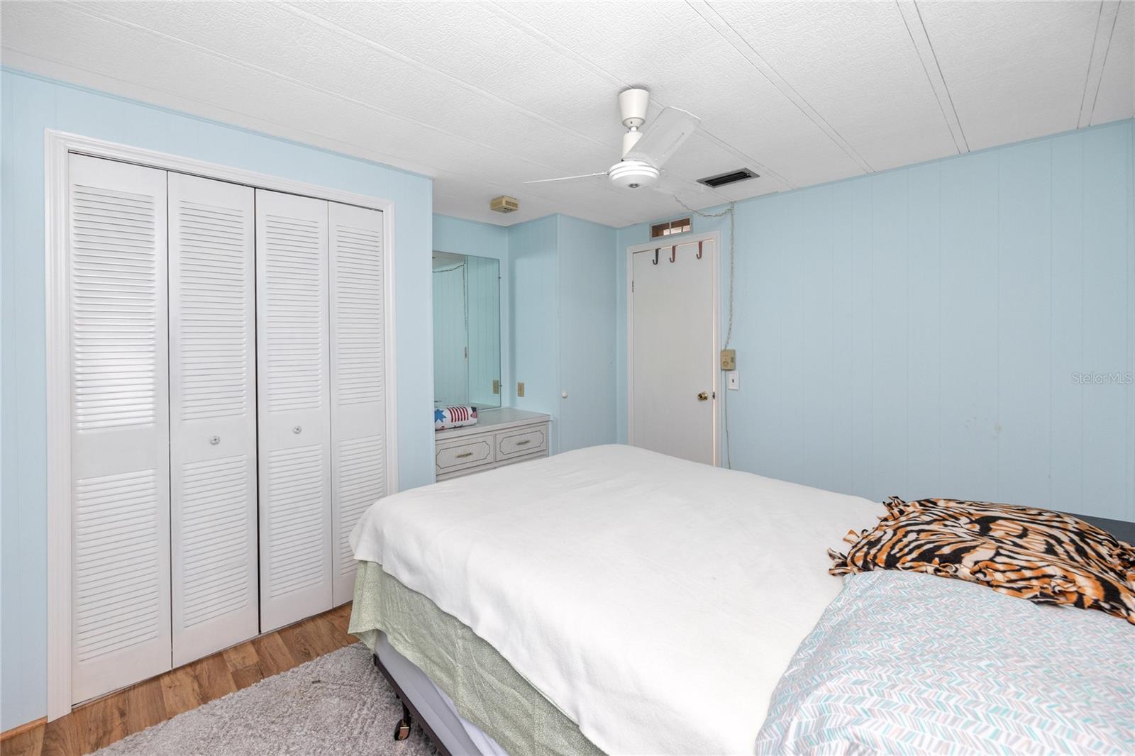 Guest room that fits a queen sized bed and features a built in storage space or area to get ready for your day.