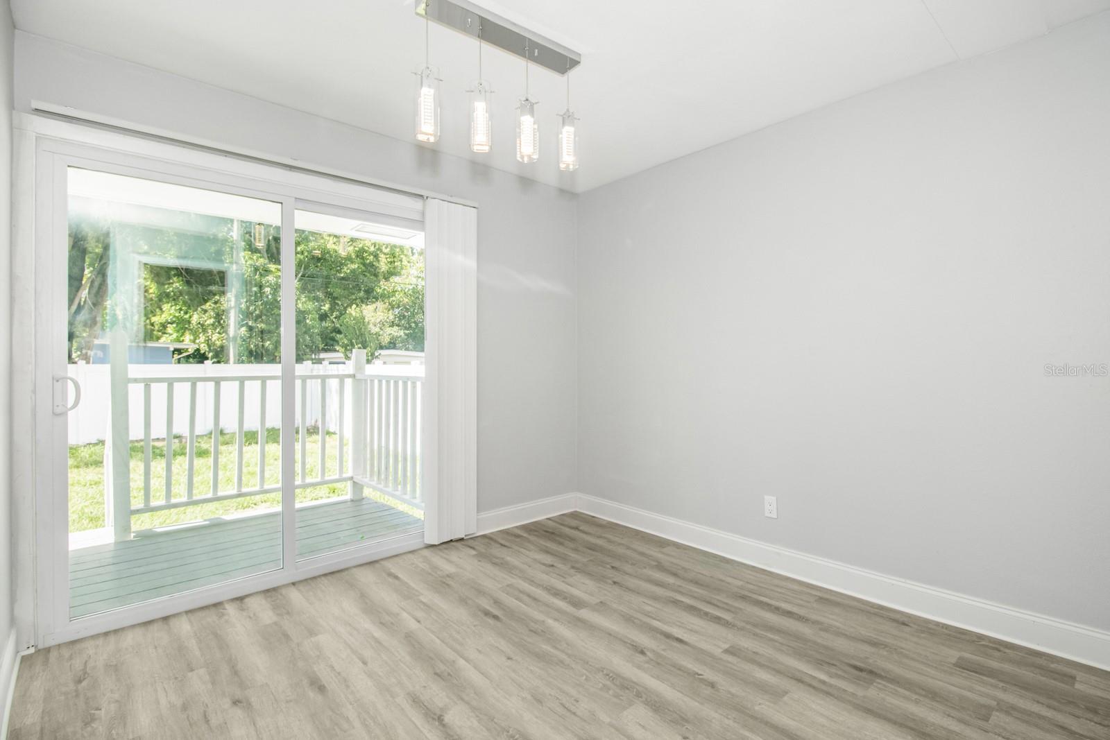 Dining Room with slider that goes out to the large fenced in backyard