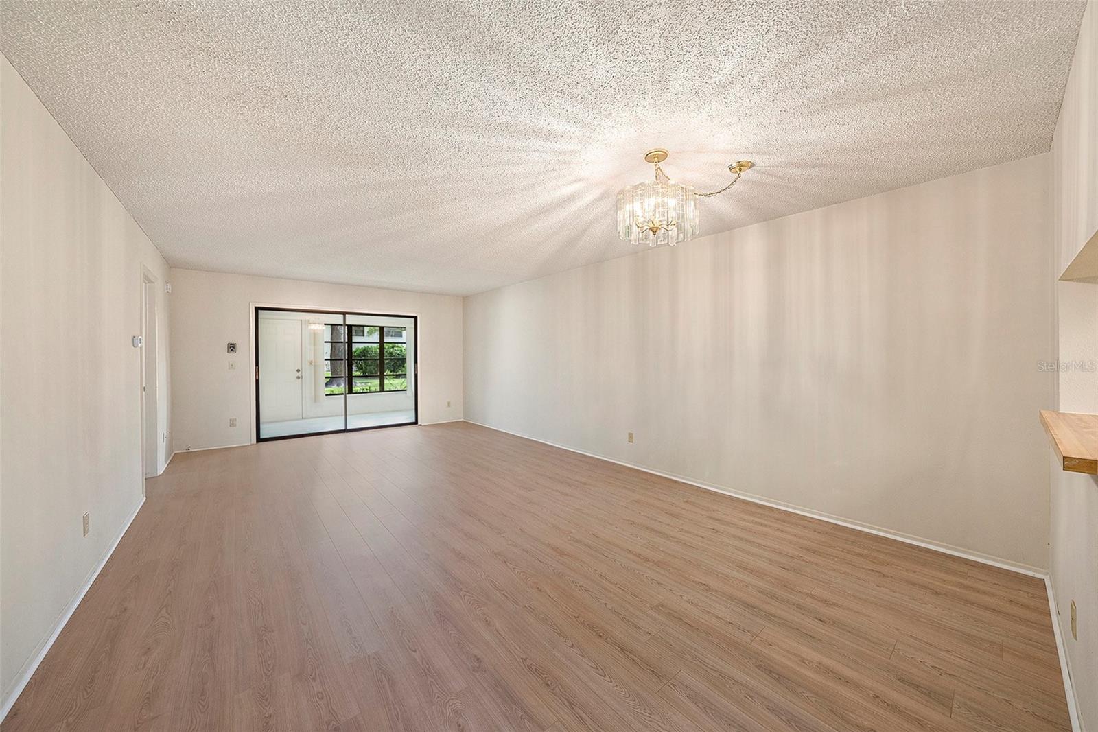 View of the Dining and Living Room Combination with New Laminate Flooring