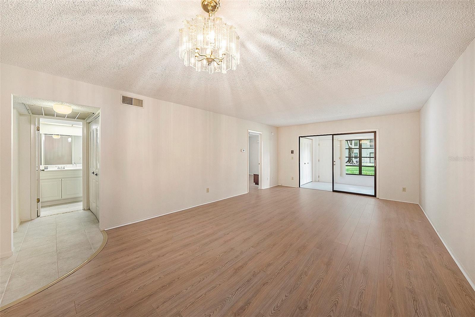 View of the Dining and Living Room Combination with New Laminate Flooring