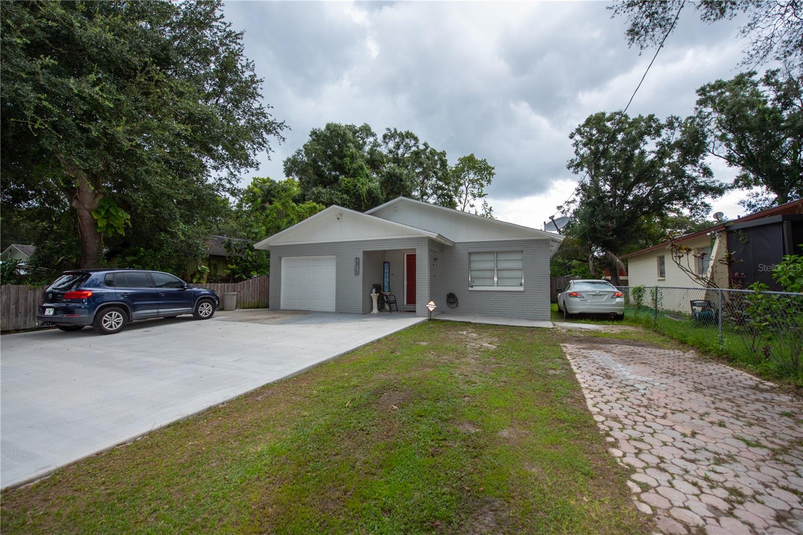 Front view of home with oversized driveway and additional parking pad