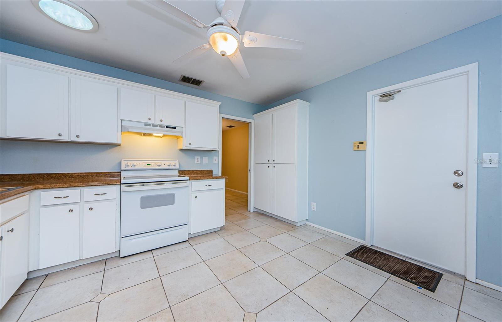 View of garage door to the right, the entry to the dining room at top right and the Large Pantry is a great Plus!