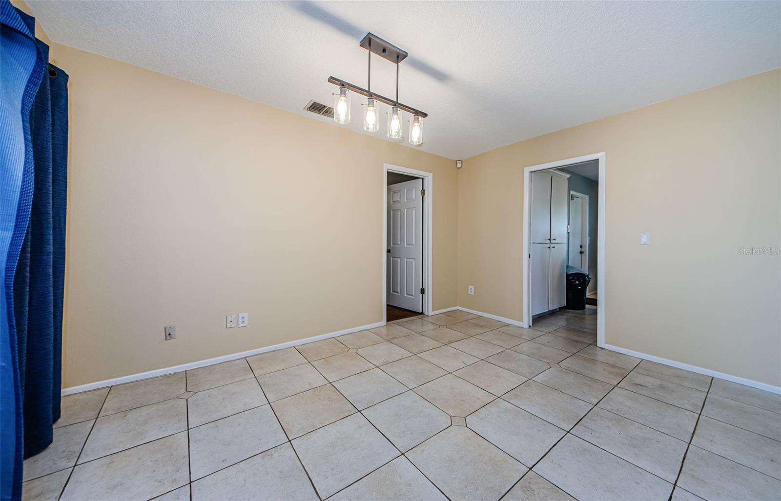 Blue curtains are for a sliding door to the screened, covered Lanai.