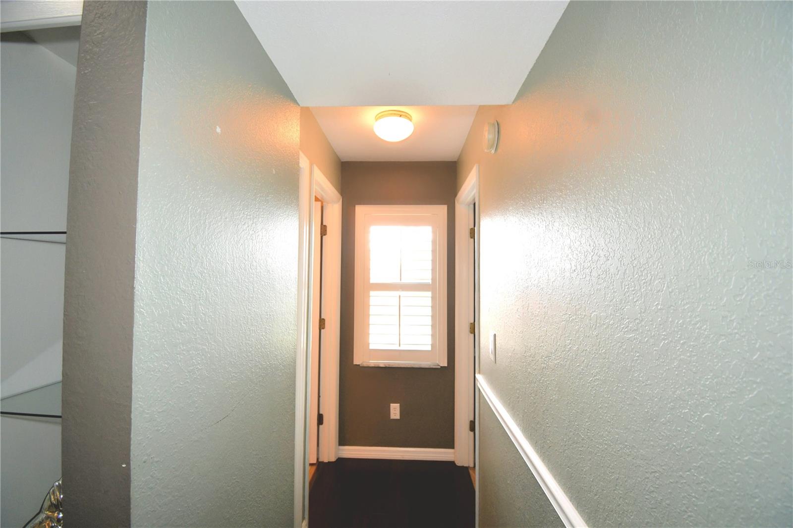 Hallway to fourth bedroom and third bath.