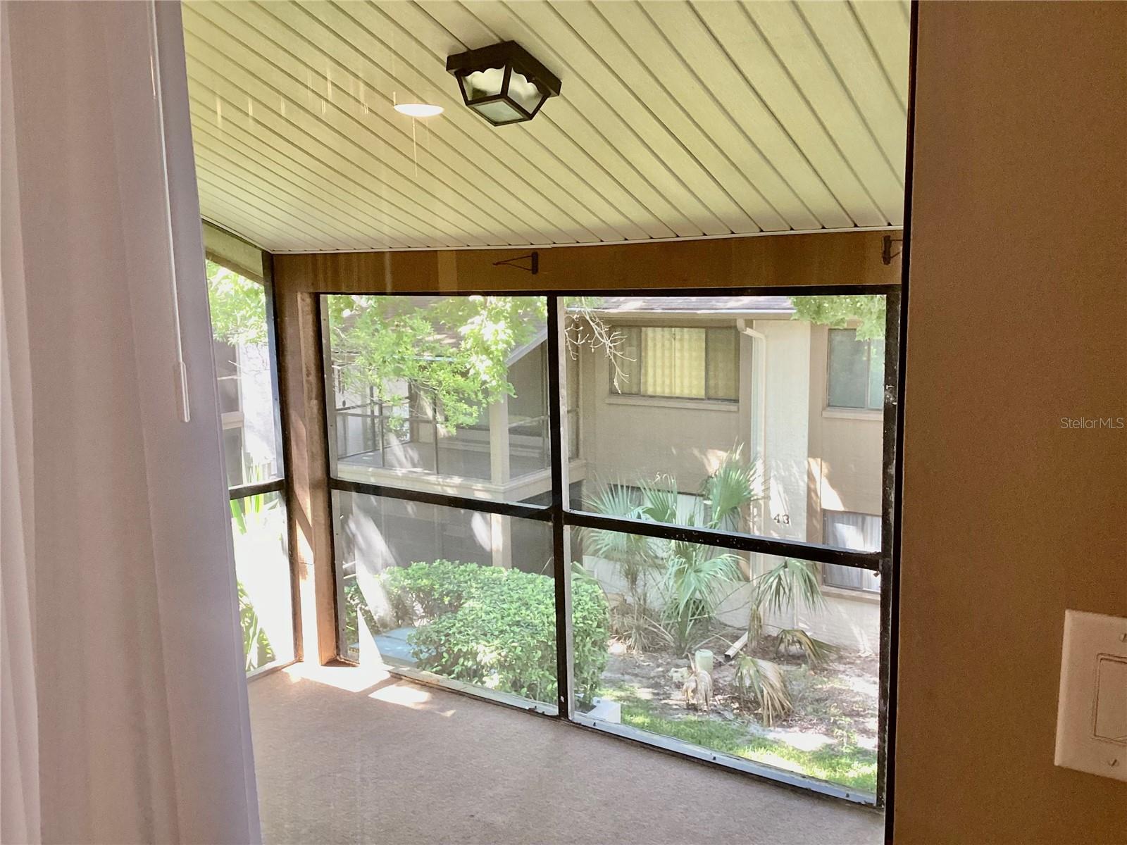 Step-down screened Florida room with new outdoor carpeting.