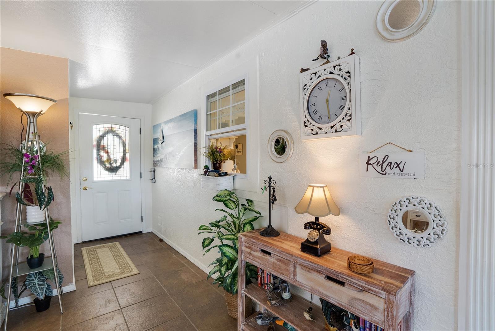 Foyer enters living room. All wall decor and furniture seen will convey with the home.