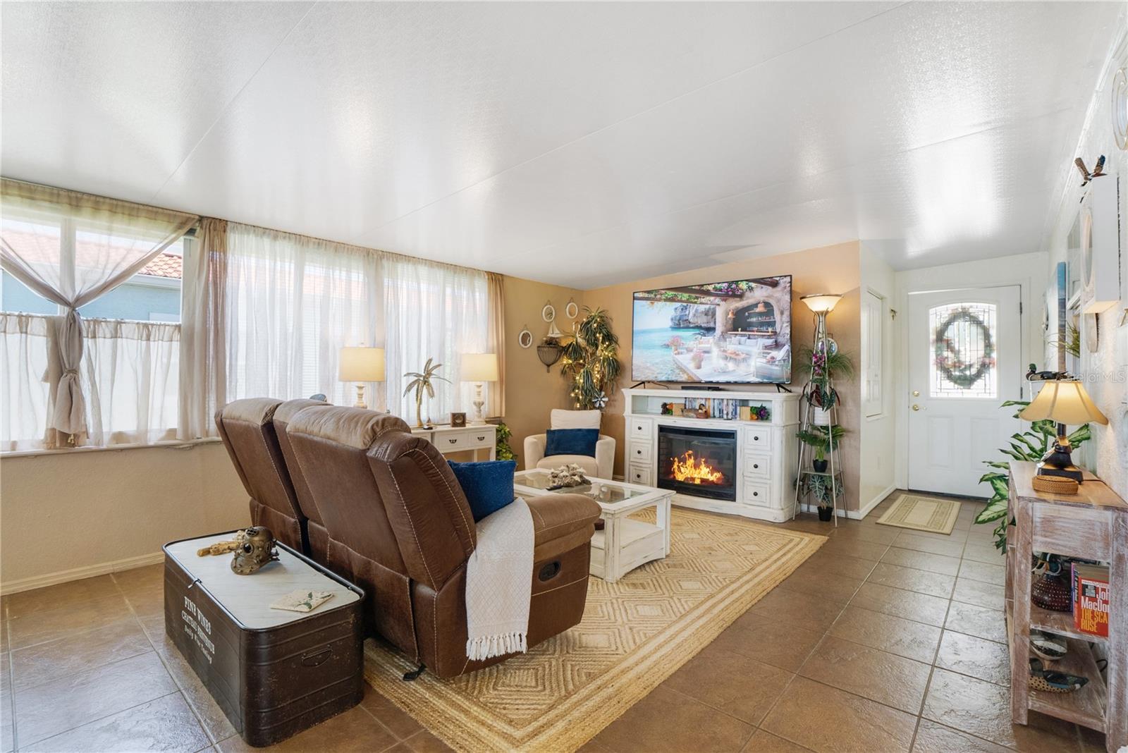 Ceramic tile flooring goes from Foyer, through living room, bar and sunroom.