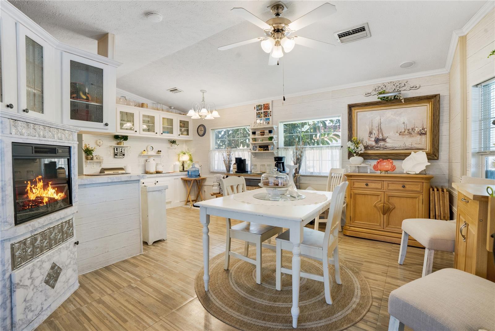 Dining room fireplace is electric. Dining room has ceiling fan with light kit.