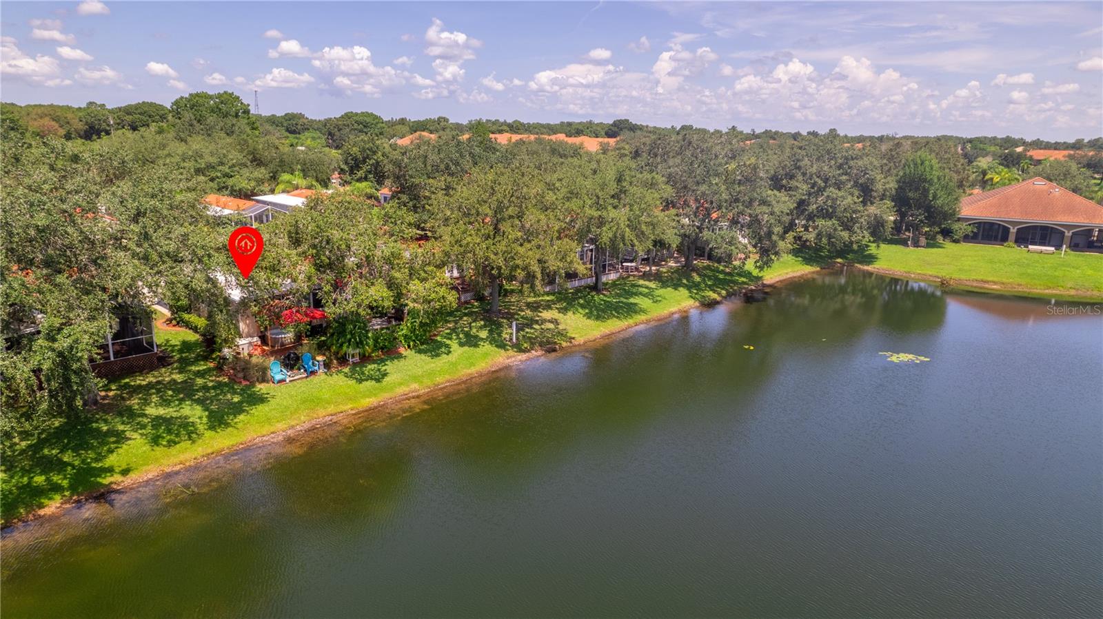 Aerial view showing home market in red. Can you see the red umbrella under the trees and blue adirondack chairs