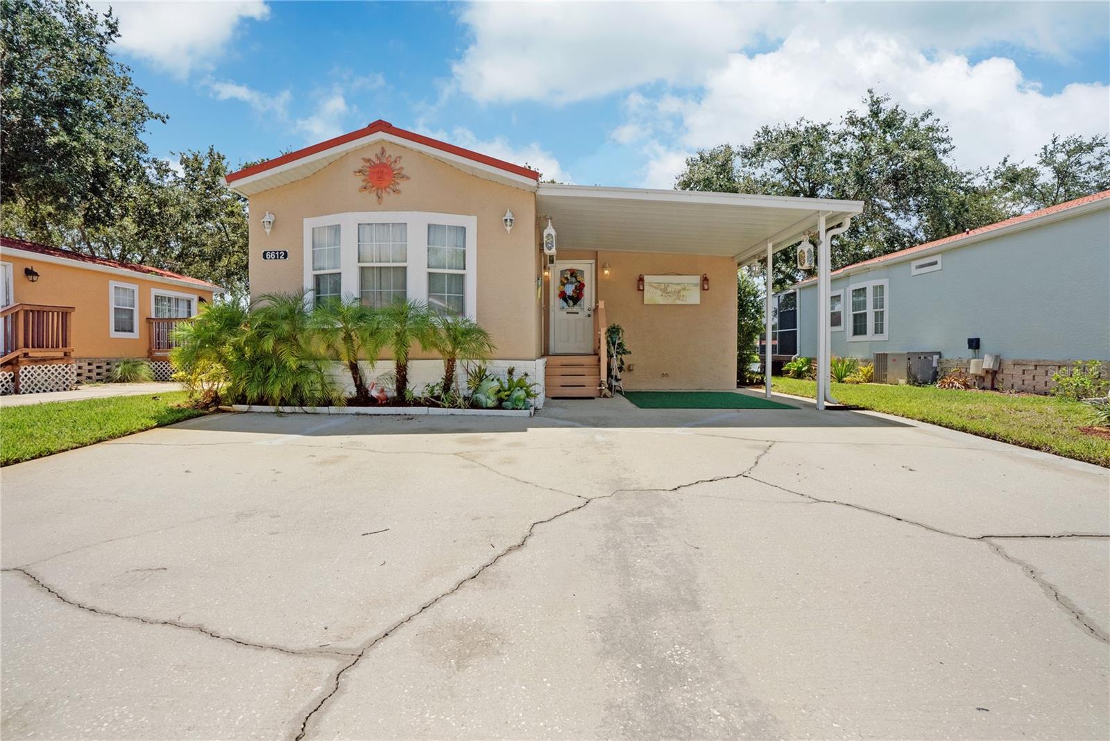 To the right of the front door is the storage room with washer and dryer, storage with shelving.