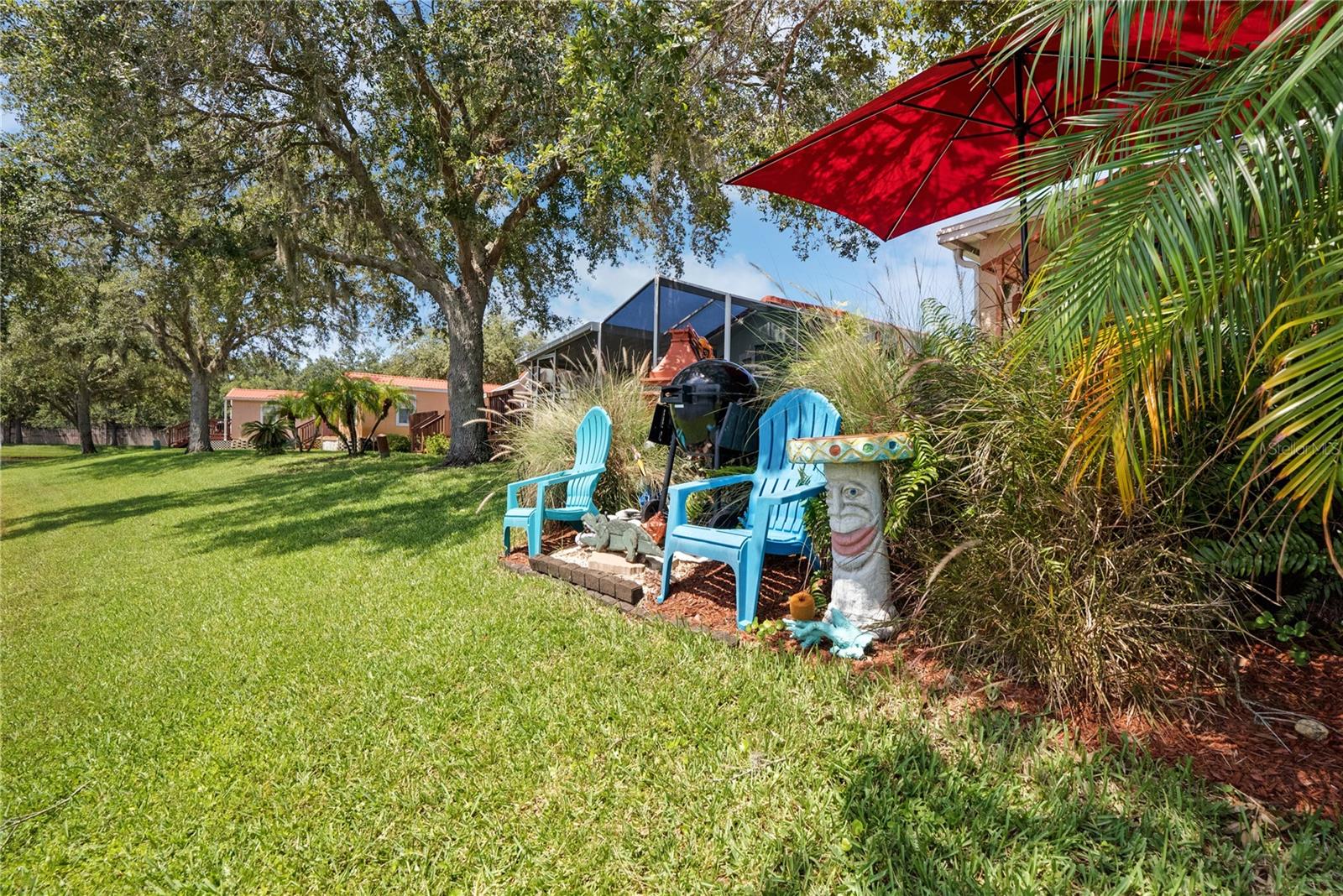 Chairs, grill, umbrella and yard art will convey