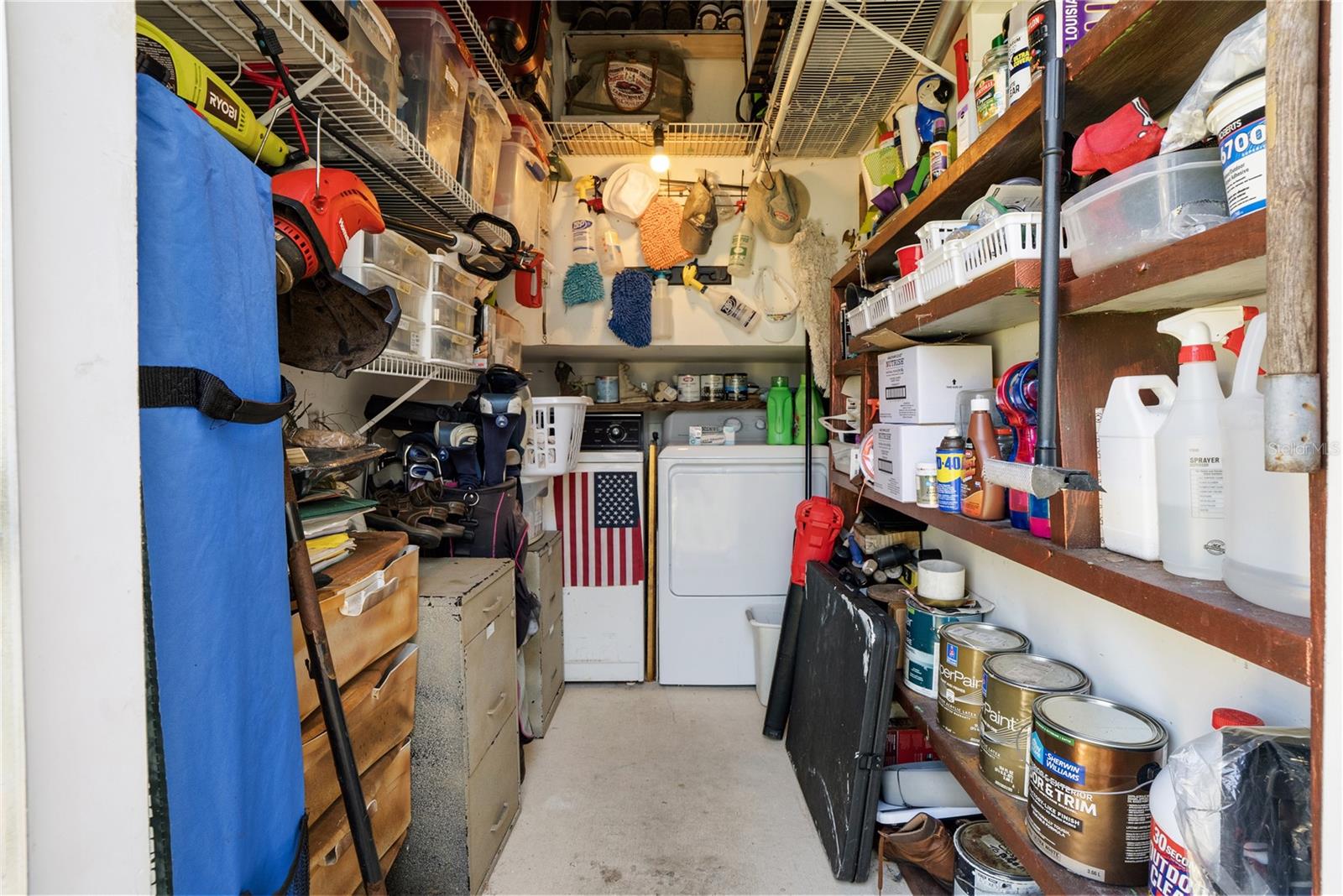 Storage room has plenty of space and shelving plus the washer and dryer