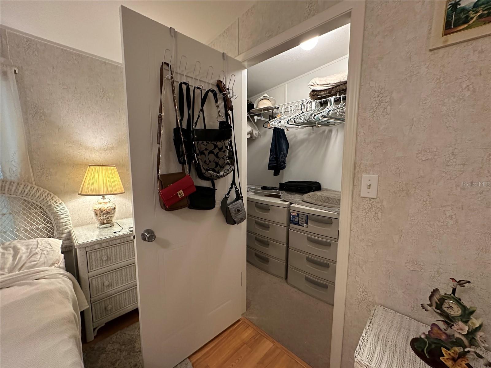 Primary bedroom walk in closet