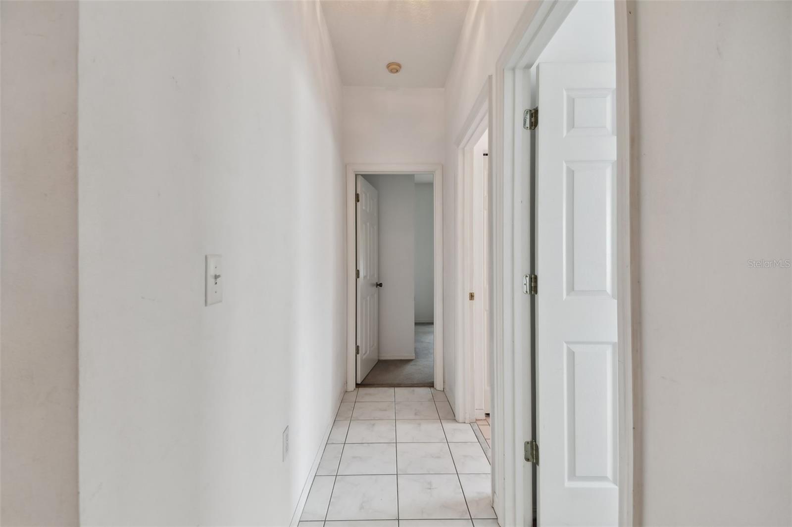 Hallway to two additional bedrooms and full bathroom