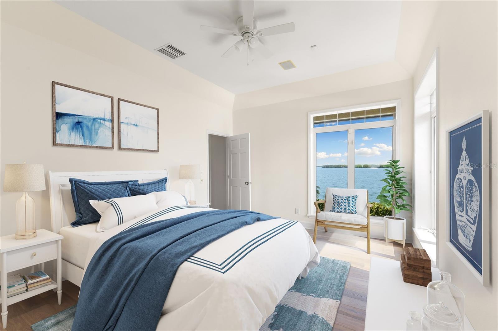 First floor guest bedroom w/ large walk-in closet and sweeping water views. Virtually staged.