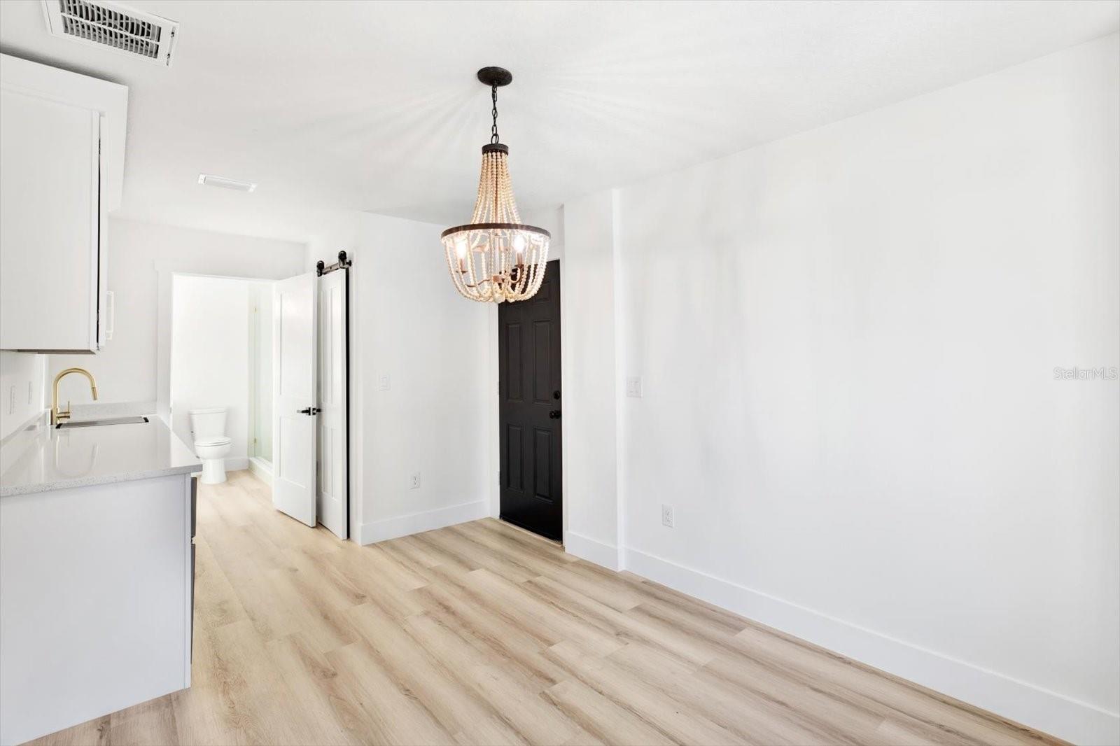 Front bedroom featuring a barn door closet and a separate private entrance