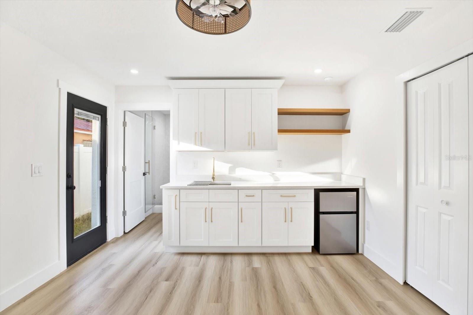 Rear bedroom 1, exterior door features encased functional blinds