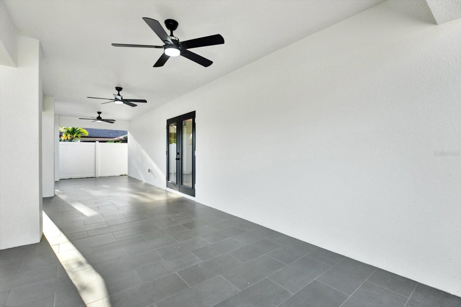 Rear porch featuring French doors and patio ceiling fans