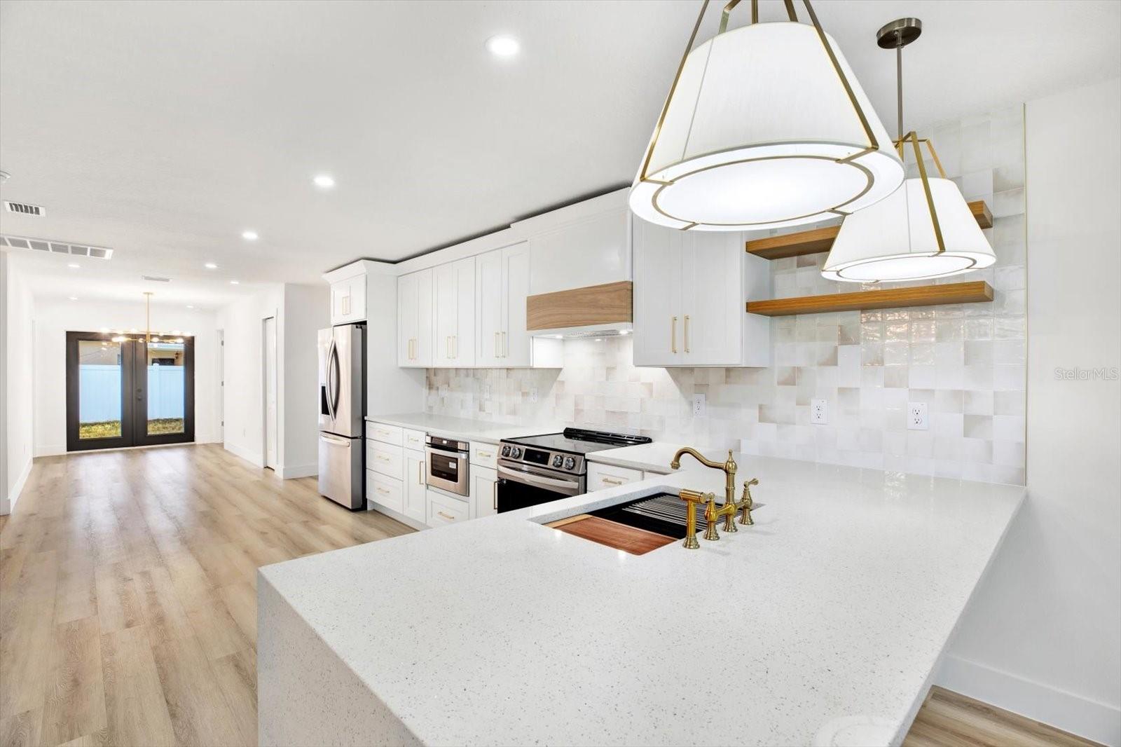 Gorgeous kitchen with quartz countertops and tile backsplash