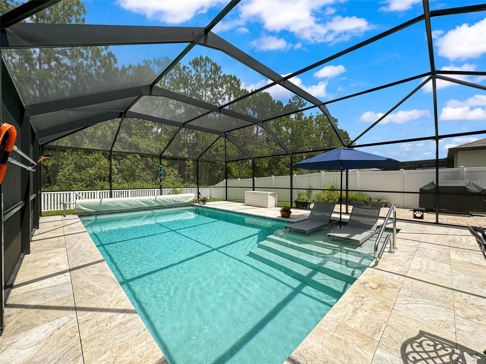 GORGEOUS NEWLY SEALED TRAVERTINE FLOORING IN THE POOL AREA