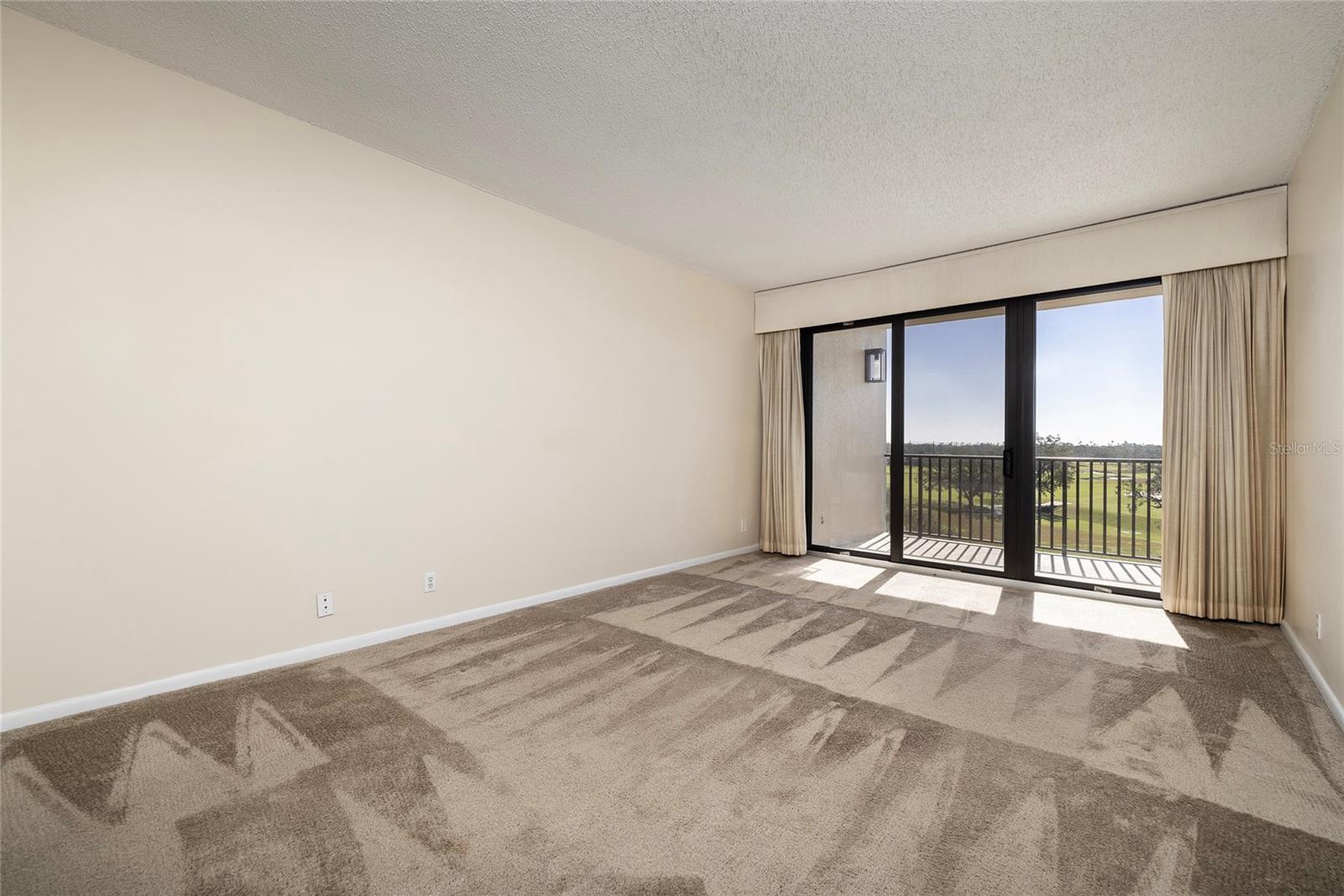 Master Bedroom with Balcony Access -- Golf Course and Water Views