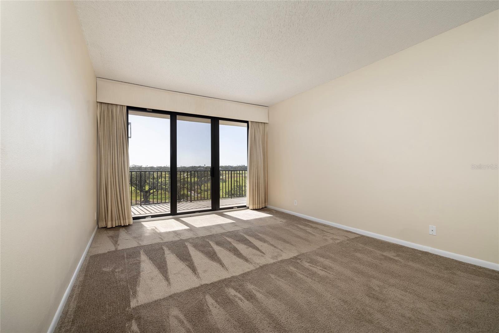 Master Bedroom with Balcony Access -- Golf Course and Water Views