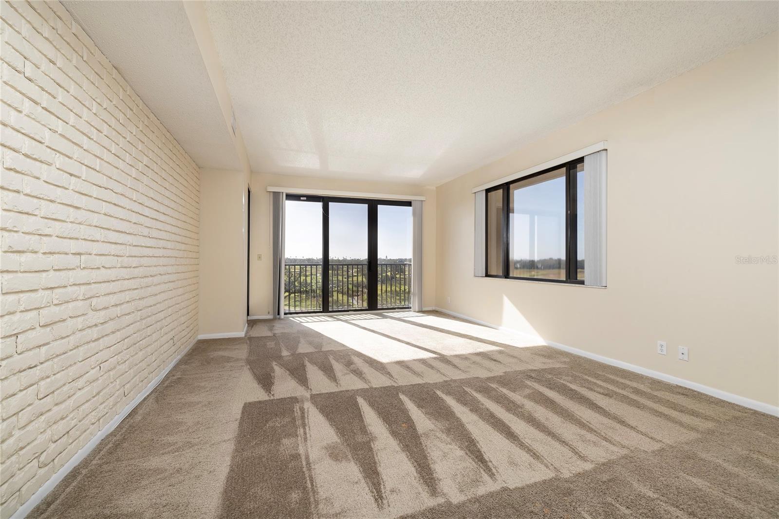 Living Room with Access to both balconies -- Golf Course and Water Views