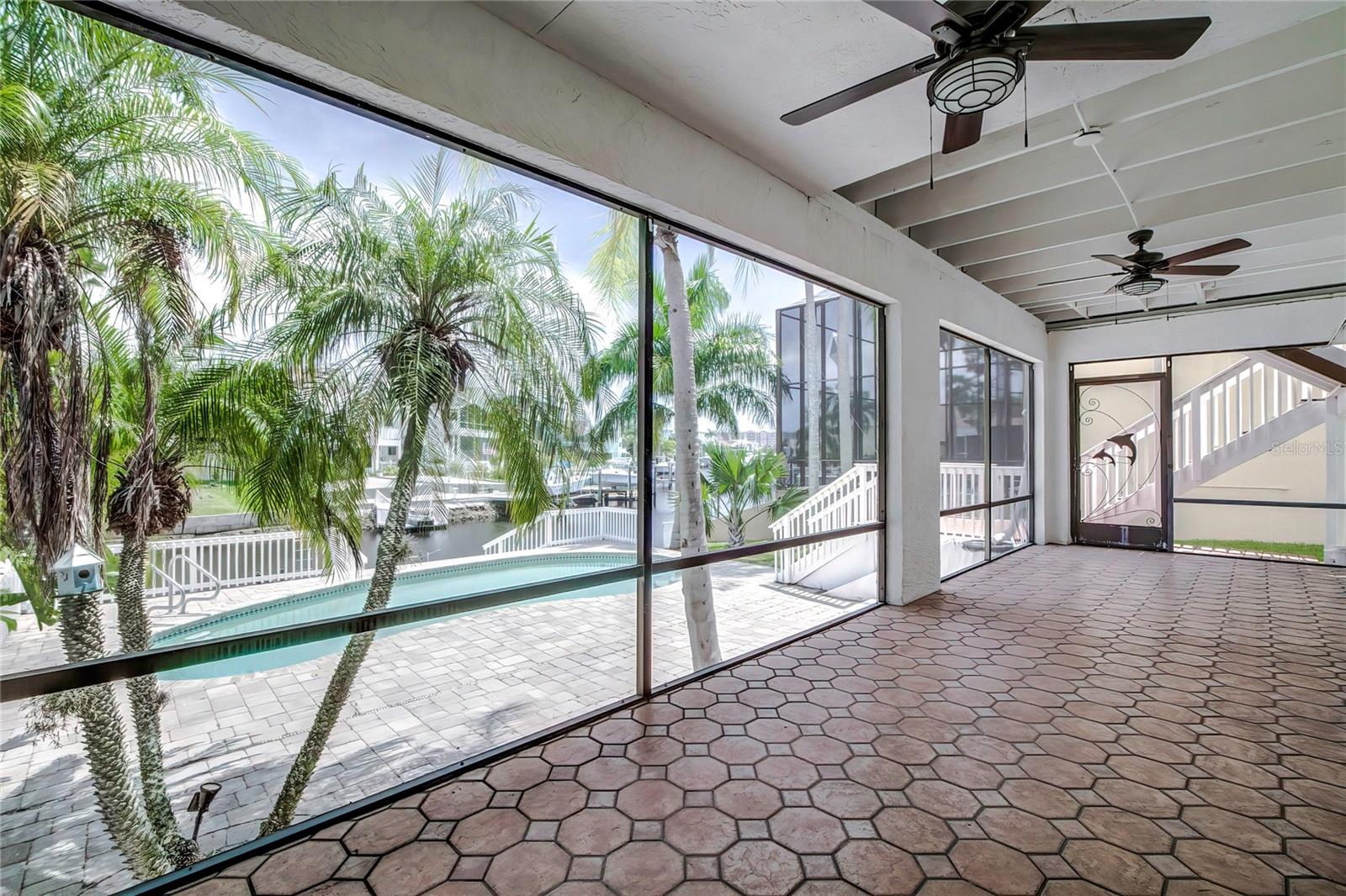 Downstairs screened porch with pool and waterview.