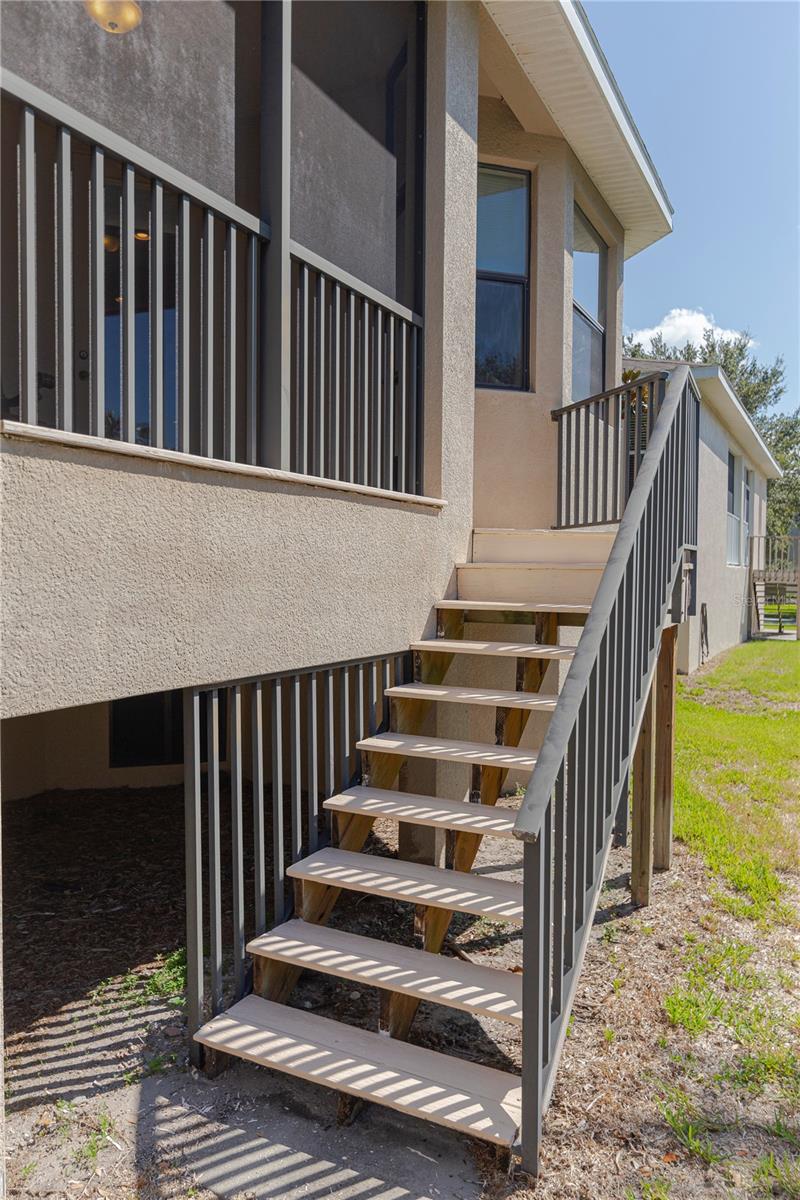 Stairway Up to screened in porch and open deck.