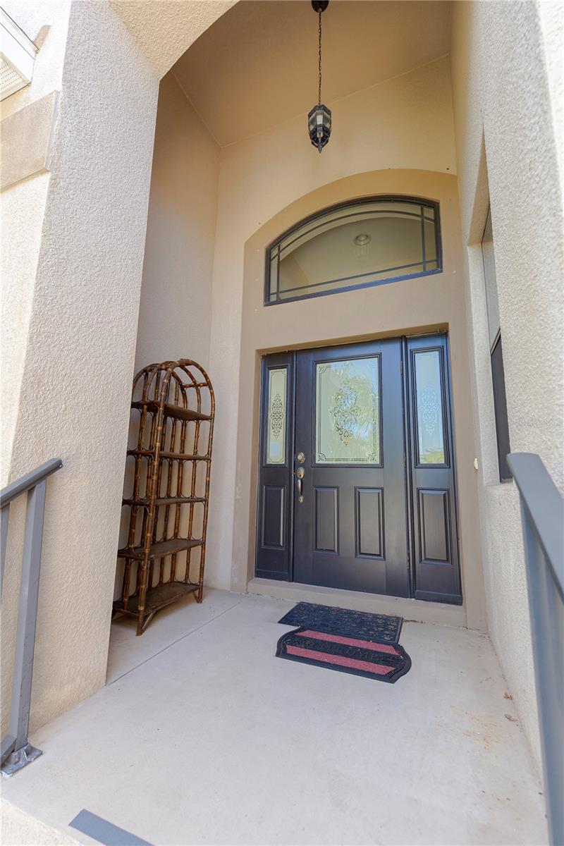 Stairs up to Screened-In Porch, and Kitchen entry.