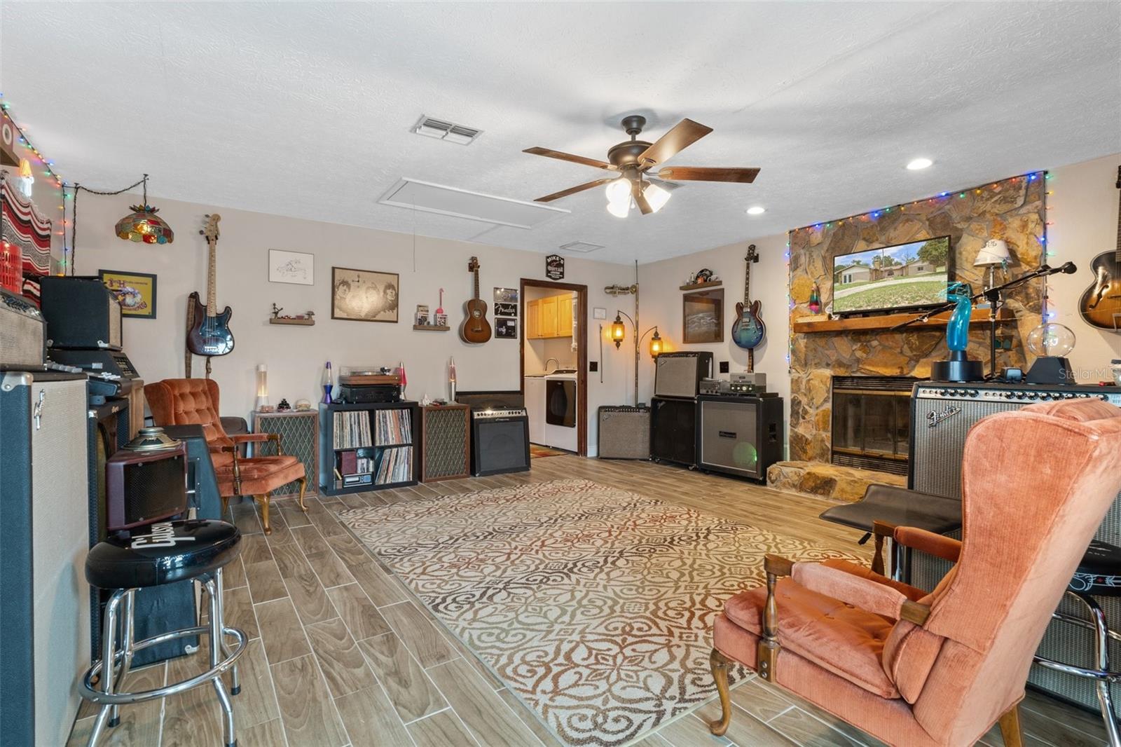 Bonus/Family Room with Wood Burning Fireplace and Wood Look Tile Flooring