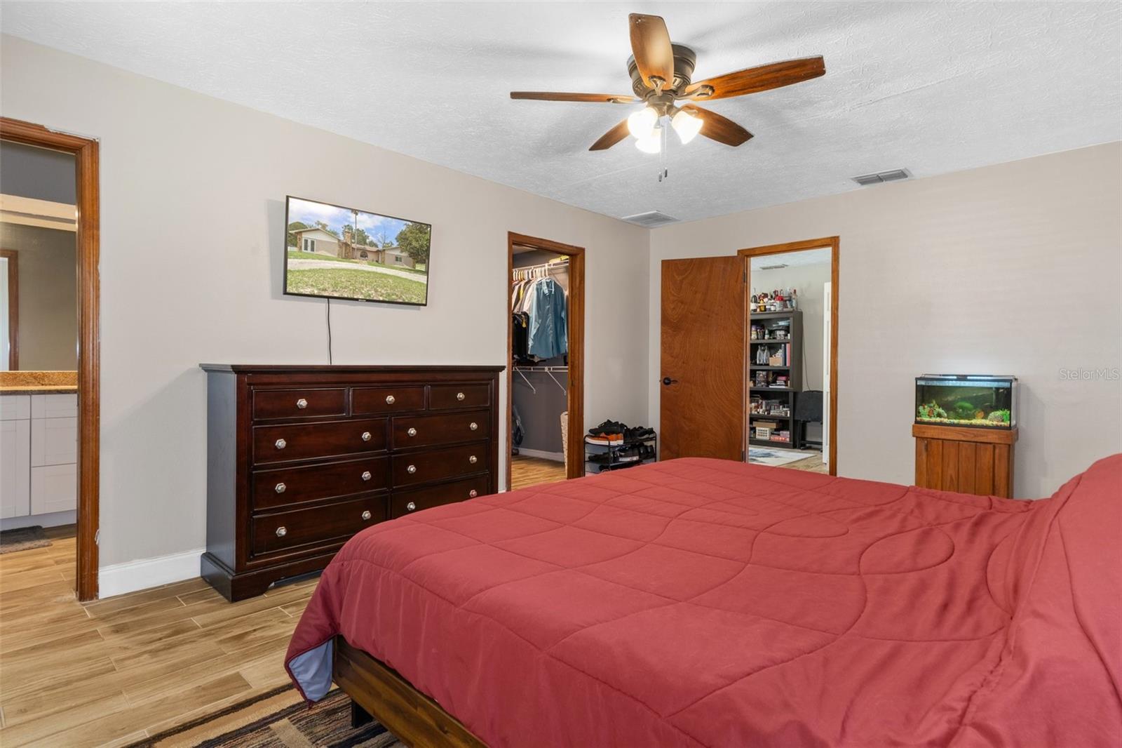 Master Bedroom with Wood Look Tile Flooring